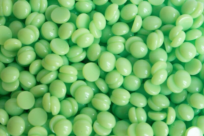 Close-up of Mojito hot wax beads showing green mint color and texture
