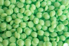 Close-up of Mojito hot wax beads showing green mint color and texture