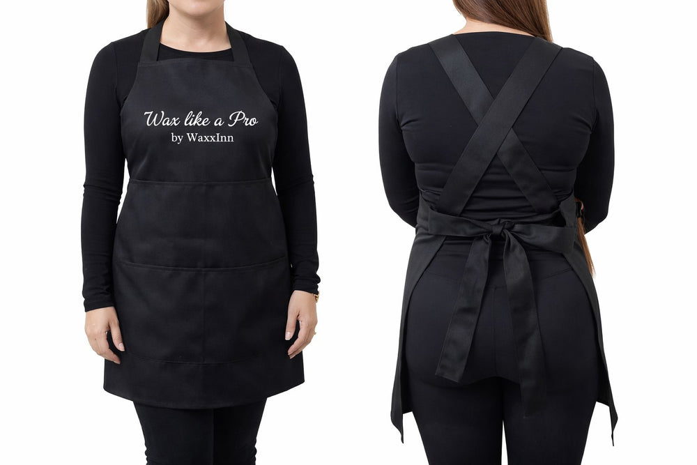 Black apron with 'Wax like a Pro by Waxthin' text worn by a person on a white background