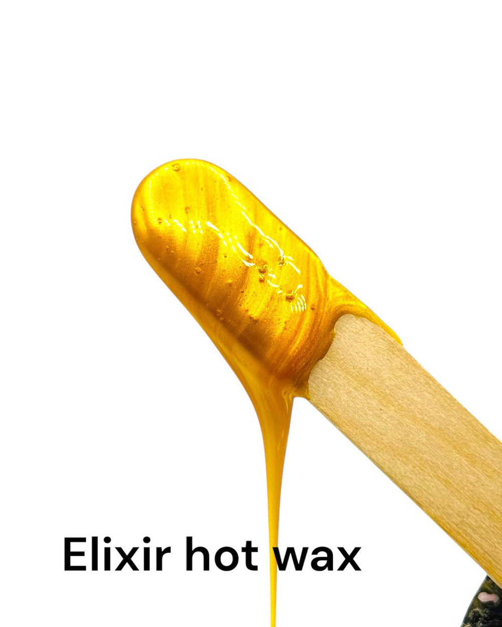 Close-up of Elixir hot wax beads showing golden amber color and texture