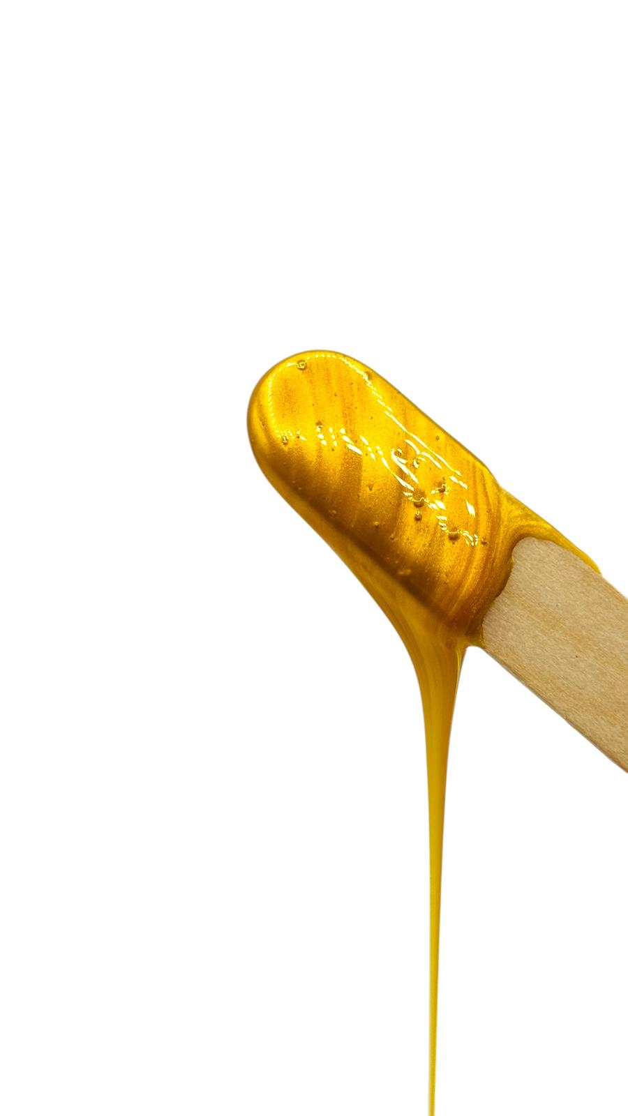 Wooden wax applicator stick with hot wax for hair removal
