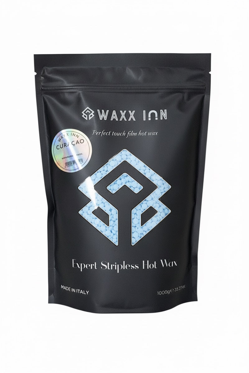 Waxx Inn Curaçao Expert Stripless Hot Wax Beads 1kg black pouch with light blue beads spilled – rosin-free hard wax for coarse hair, professional formula made in Italy