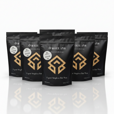 Waxx Inn Elixir Expert Stripless Hot Wax Beads 1kg pack of 6 – six black pouches with golden Elixir label staged on white background with reflection, professional hard wax made in Italy