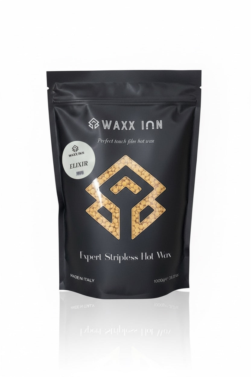 Waxx Inn Elixir Expert Stripless Hot Wax Beads 1kg – black pouch with golden Elixir label and warm gold wax beads, stripless hard wax for all hair types, professional formula made in Italy