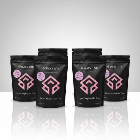 Waxx Inn Pink Candy Expert Stripless Hot Wax Beads 1kg pack of 4 – four black pouches with Pink Candy label staged on reflective white surface, professional hard wax made in Italy